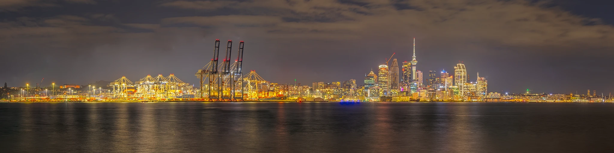 Auckland nighttime skyline and waterfront viewed across Waitematā Harbour, New Zealand